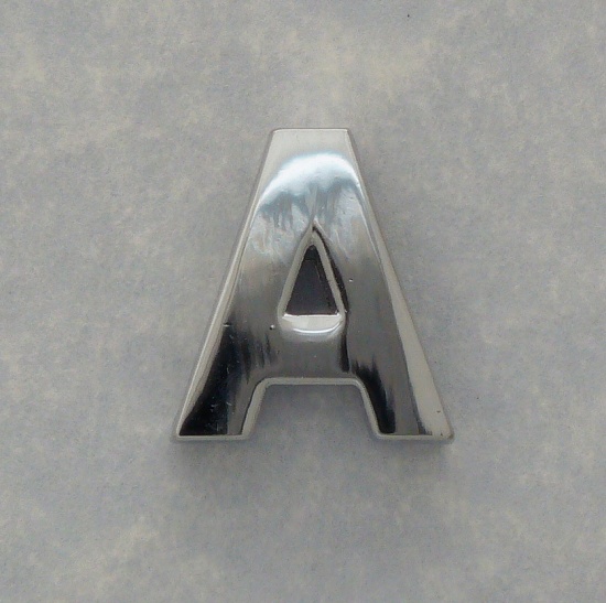 A chrome steel letter